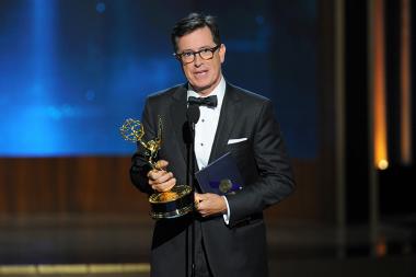 Stephen Colbert accepts the award for outstanding supporting actor in a miniseries or a movie on behalf of Martin Freeman for his work on Sherlock: His Last Vow (Masterpiece) at the 66th Primetime Emmys. 