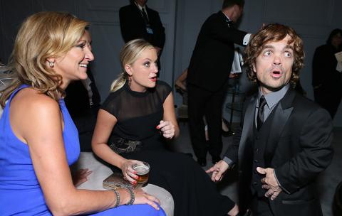 Edie Falco, Amy Poehler and Peter Dinklage share a look of surprise in the Audi Green Room at the 65th Emmy Awards.