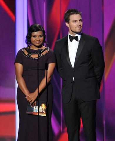 Mindy Kaling and Stephen Amell on stage at the 65th Emmys
