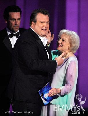 Actor Eric Stonestreet (C) accepts his award from actors Jon Hamm (L) and Betty White onstage at the 62nd Annual Primetime Emmy 