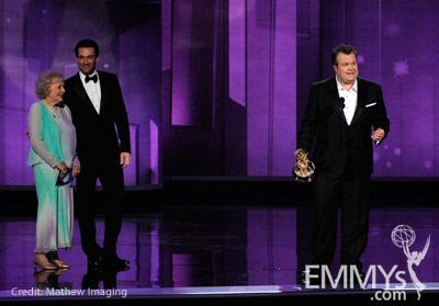 Actor Eric Stonestreet (R) accepts his award from actors Betty White (L) and Jon Hamm onstage at the 62nd Annual Primetime Emmy 