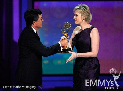 Actress Jane Lynch (R) accepts her award from comedian Stephen Colbert onstage at the 62nd Annual Primetime Emmy Awards held at 