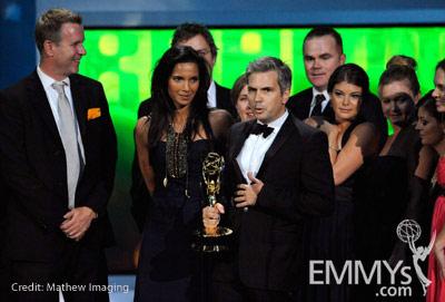 TV personality Padma Lakshmi and producer Dan Cutforth (C) and the cast and crew of Top Chef accept an award onstage at the 62nd