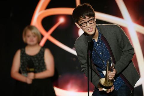 Hyungjik Lee of Florida State University accepts his award in the Children's Program category for "Lemonopolis" at the 35th College Television Awards as presenter Lauren Potter looks on.