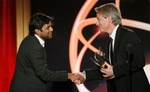 Graham Yost presents Shubhashish Bhutiani, left, of School of Visual Arts with the Directing Award for "Kush" at the 35th College Television Awards
