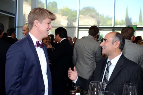 Tim Kolenot and Henry Safarian chat at the 67th Los Angeles Area Emmy Awards cocktail party July 25, 2015, at the Skirball Cultural Center in Los Angeles, California.