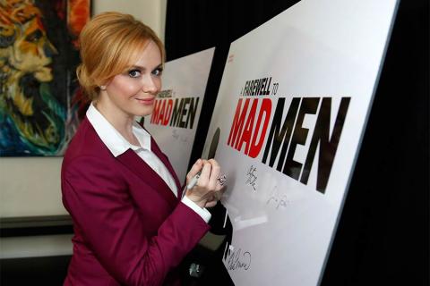 Christina Hendricks signs the poster at "A Farewell to Mad Men," May 17, 2015 at the Montalbán Theater in Hollywood, California.