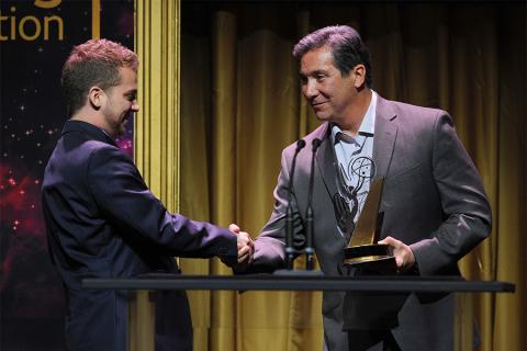 Cory Sanchez accepts an award from Benito Martinez at the 36th College Television Awards at the Skirball Cultural Center in Los Angeles, California, April 23, 2015.