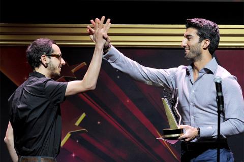 Justin Baldoni (R) congratulates Eddie Roqueta on his award at the 36th College Television Awards at the Skirball Cultural Center in Los Angeles, California, April 23, 2015.