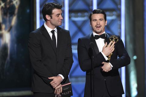 James Wolk and Jason Ritter accept an award for RuPaul Charles, who could not attend, at the 2017 Creative Arts Emmys.