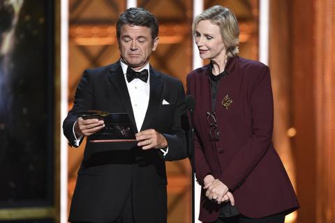 John Michael Higgins and Jane Lynch on stage at the 2017 Creative Arts Emmys.