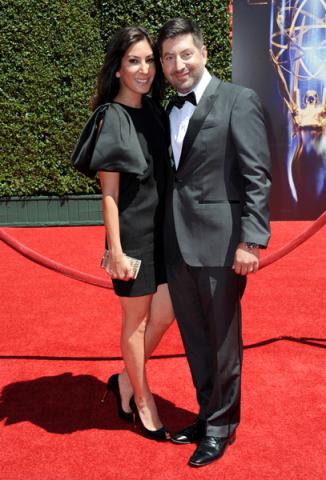 Suzann Levine, left, and James S. Levine arrive for the 2014 Primetime Creative Arts Emmys.
