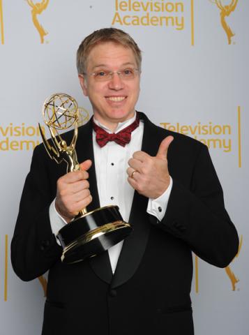 The Daily Show with Jon Stewart editor Eric Davies celebrates his win at the 2014 Primetime Creative Arts Emmys.