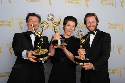 Paul Ghirardani, Deborah Riley and Rob Cameron celebrate their win at the 2014 Primetime Creative Arts Emmys.