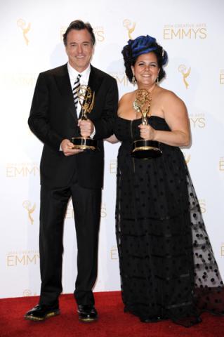 The Oscars art direction team members Derek McLane (l) and Gloria Lamb (r) celebrate their win at the 2014 Primetime Creative Arts Emmys.