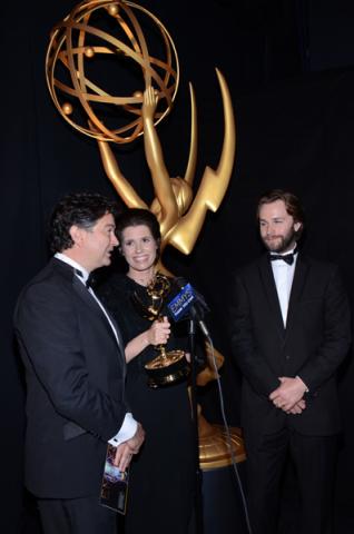 Game of Thrones art direction team members Paul Ghirardani (l), Deborah Riley (c) and Rob Cameron (r) celebrate their win at the 2014 Primetime Creative Arts Emmys.