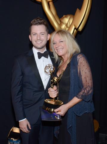 Downton Abbey hairstylists Adam James Phillips (l) and Magi Vaughan (r) celebrate their win at the 2014 Primetime Creative Arts Emmys.