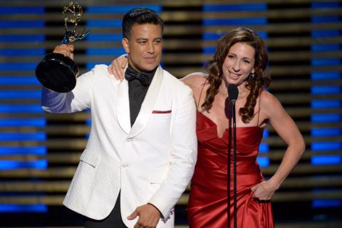 Choreographers Napoleon D'umo (l) and Tabitha D'umo (r) of So You Think You Can Dance accept an award at the 2014 Primetime Creative Arts Emmys.