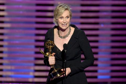 Hollywood Game Night host Jane Lynch accepts an award at the 2014 Primetime Creative Arts Emmys.
