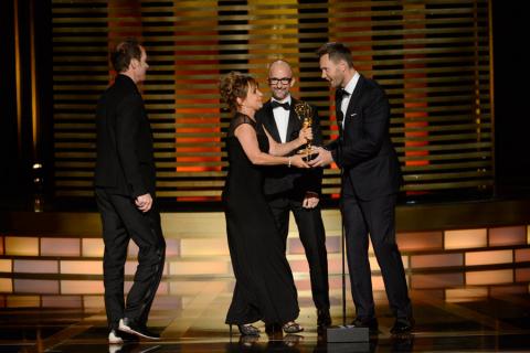 Dancing With the Stars camera operators Seth Saint Vincent (l) and Bettina Levesque accept an award from Jim Rash and Joel McHale (r) at the 2014 Primetime Creative Arts Emmys.