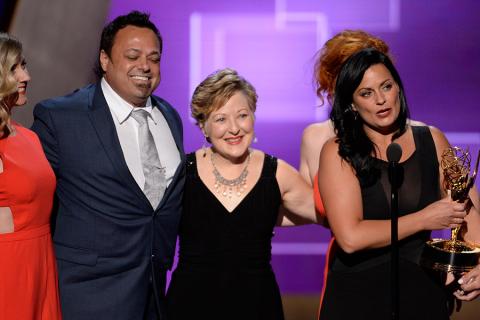 The team of Saturday Night Live accepts their award at the 2015 Creative Arts Emmys.