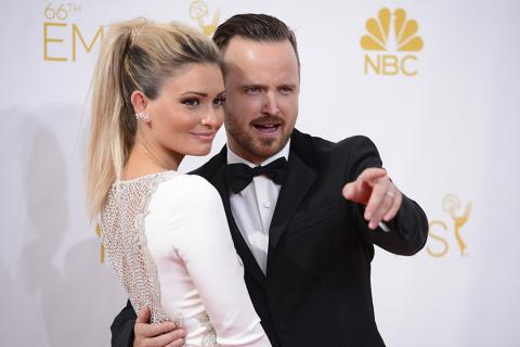 Lauren Parsekian (l) and Aaron Paul of Breaking Bad arrive at the 66th Emmy Awards.