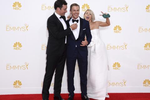 Jimmy Fallon (l) Derek Hough (c) and Julianne Hough (r) arrive at the 66th Emmy Awards.
