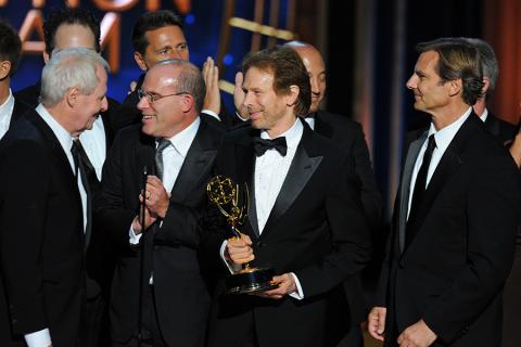 Jerry Bruckheimer (second from right) and the producers of The Amazing Race accept an award at the 66th Emmys. 