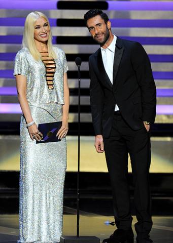 Gwen Stefani (l) and Adam Levine (r) of The Voice present an award at the 66th Emmys.