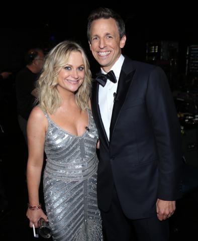 Amy Poehler (l) of Parks and Recreation and Seth Meyers (r) of Late Night With Seth Meyers backstage at the 66th Emmys.