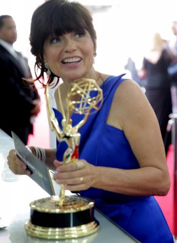 Gail Mancuso of Modern Family celebrates backstage at the 66th Emmys. 