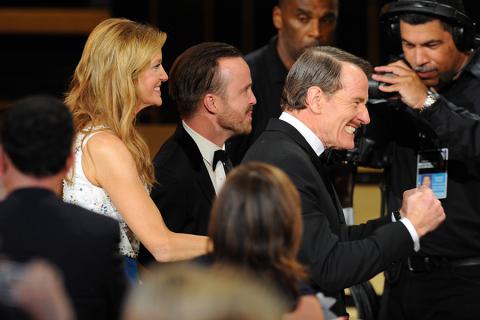 Anna Gunn, Aaron Paul (c) and Bryan Cranston (r) accept the award for outstanding drama series for their work on Breaking Bad at the 66th Emmys. 