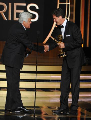 Jay Leno (l) presents Steven Levitan (r) of Modern Family an award at the 66th Emmys. 