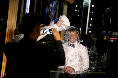 Seth Meyers of Late Night With Seth Meyers does the ALS ice bucket challenge backstage at the 66th Emmys.  