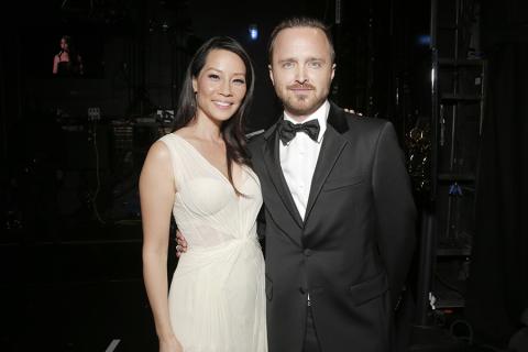 Lucy Liu (l) of Elementary and Aaron Paul (r) of Breaking Bad backstage at the 66th Emmys. 