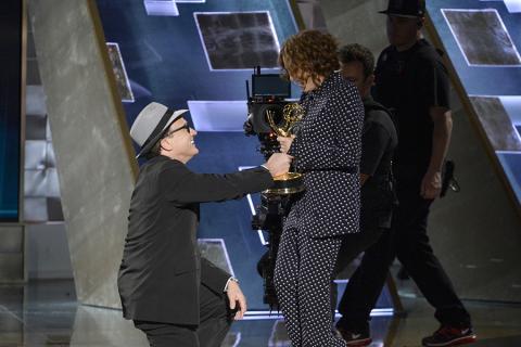 Bradley Whitford presents Jill Soloway an award at the 67th Emmy Awards.