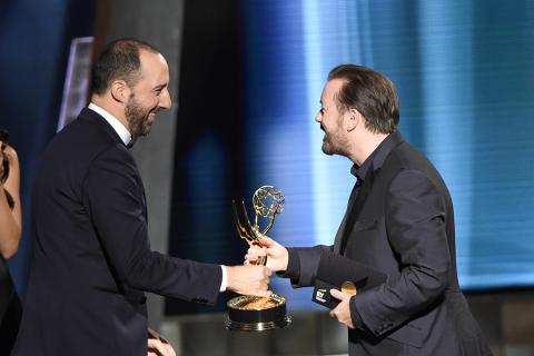 Tony Hale accepts an award from Ricky Gervais at the 67th Emmy Awards.
