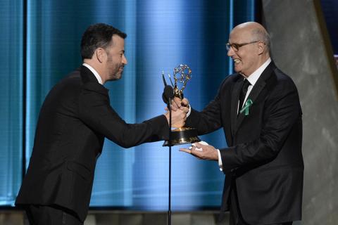 Jimmy Kimmel presents an award to Jeffrey Tambor at the 67th Emmy Awards.