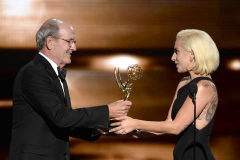 Richard Jenkins accepts his award from Lady Gaga at the 67th Emmy Awards.