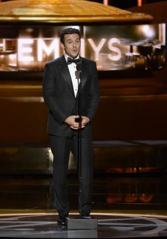 Fred Savage presents an award at the 67th Emmy Awards.