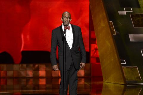 Reg E. Cathey presents the award at the 67th Emmy Awards.