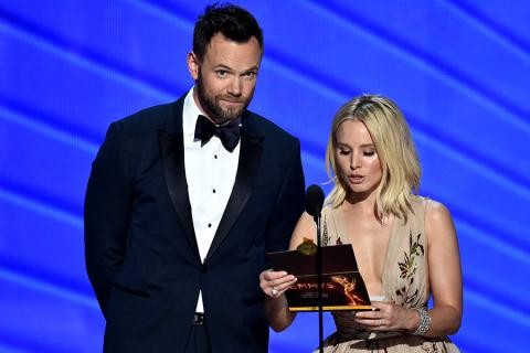 Joel McHale and Kristen Bell present an award at the 2016 Primetime Emmys.
