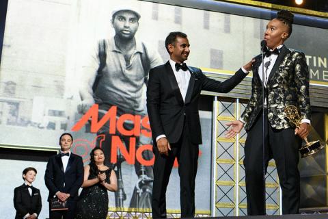 Aziz Ansari and Lena Waithe accept their award on stage at the 69th Primetime Emmys