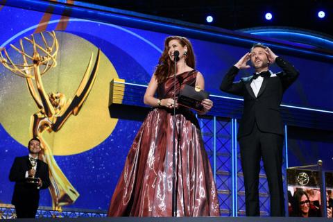 Debra Messing and Chris Hardwick on stage at the 69th Emmy Awards.