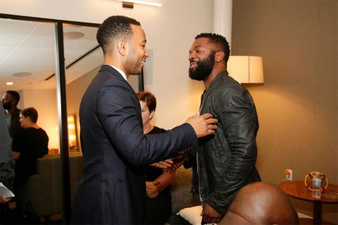 John Legend greets panel moderator Baratunde Thurston at Unlock Our Potential at the Television Academy's Saban Media Center, August 9, 2016.