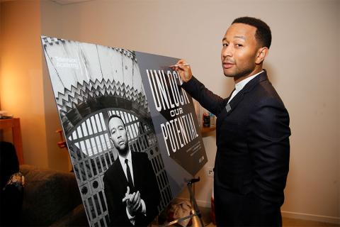 John Legend signs a poster at Unlock Our Potential at the Television Academy's Saban Media Center, August 9, 2016.