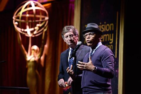 Nigel Lythgoe and Television Academy governor Rickey Minor present an award at the 36th College Television Awards at the Skirball Cultural Center in Los Angeles, California, April 23, 2015.
