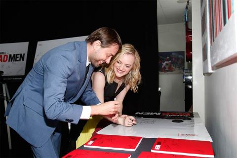 Actors Vincent Kartheiser and Elisabeth Moss sign posters at "A Farewell to Mad Men," May 17, 2015 at the Montalbán Theater in Hollywood, California.