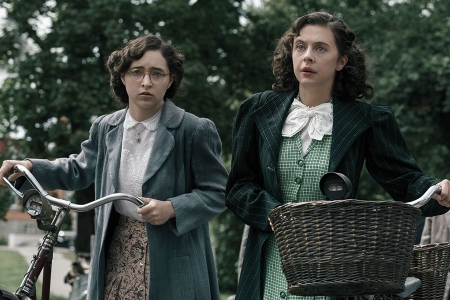 Margot Frank (Ashley Brooke) and Miep Gies (Bel Powley) arrive at a government checkpoint, where Gies's quick thinking gets them past the Nazi guards.