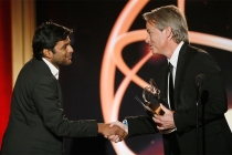 Graham Yost presents Shubhashish Bhutiani, left, of School of Visual Arts with the Directing Award for "Kush" at the 35th College Television Awards